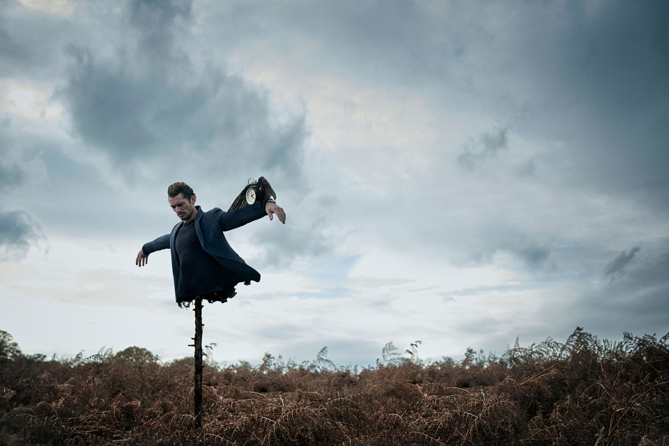 A man flying through the air on a cloudy day
